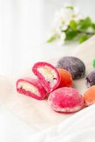 Multi-colored Japanese cakes Mochi in a white plate photo