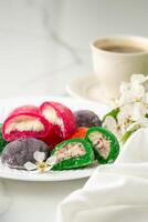 Multi-colored Japanese cakes Mochi in a white plate photo