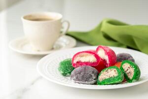 Multi-colored Japanese cakes Mochi in a white plate photo