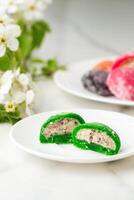 Multi-colored Japanese cakes Mochi in a white plate photo