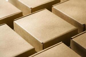 Brown cardboard boxes arranged on a neutral background in a warehouse setting during daylight hours photo
