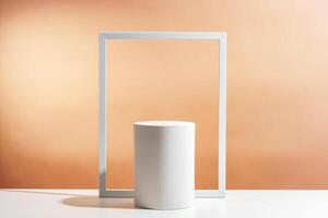 Minimalistic display of a white cylindrical object framed by a white rectangular border against a soft orange background photo