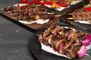 Grilled meat skewers barbecue served on board photo