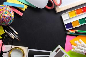 Desk of an artist with lots of stationery objects photo