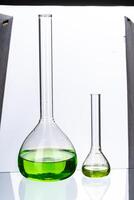 Glassware with liquids for laboratory analysis isolated on white photo