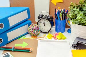 Work place of a creative person with a variety of colorful stationery objects photo