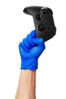 game console controller in gamer gloved hands. Games during isolation at home photo