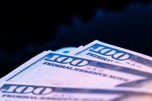 Dollars in front of a monitor with a price chart. Forex and trading. photo