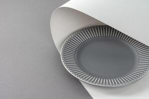 Glossy new ceramic dishware on paper background photo