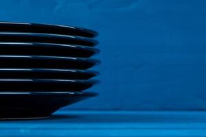 Dark blue crockery on blue wooden background photo