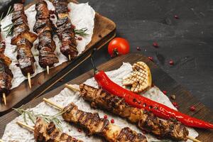 Grilled meat skewers barbecue served on board photo