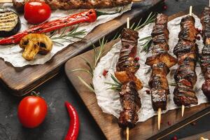 Grilled meat skewers barbecue served on board photo