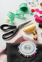 Crafting essentials for sewing projects displayed on a table with fabric, threads, and tools photo