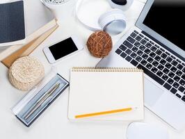 White office desk table with a lot of things on it. Top view photo