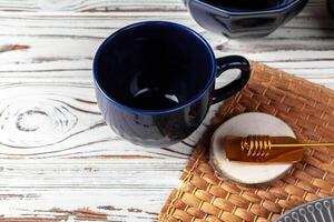 Still life photo of empty tea cup with honey spoon