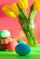 Vibrant colored eggs in a nest on green. Easter concept photo