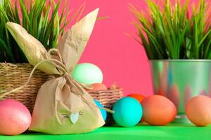 Vibrant colored eggs in a nest on green. Easter concept photo