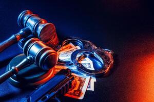 Gun and judge's gavel on the table. Crime, robbery, attack concept photo
