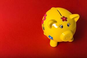 Piggy bank on red background photo