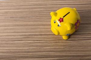 Piggy bank on wood table top photo