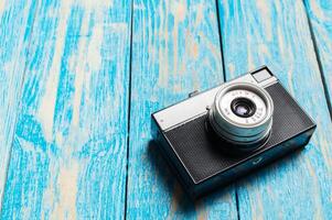 Old retro camera on wooden table background photo