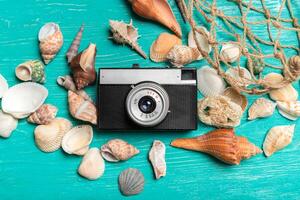 Old retro camera on wooden table background photo
