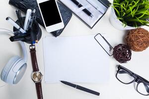 White office desk table with a lot of things on it. Top view photo