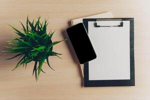 Top view workspace with blank notebook and pen on wooden table photo