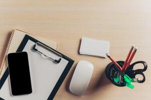 Top view workspace with blank notebook and pen on wooden table photo