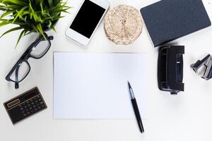 White office desk table with a lot of things on it. Top view photo