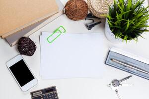 White office desk table with a lot of things on it. Top view photo