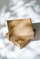 Freshly packed cardboard boxes resting on a white surface, illuminated by soft natural light photo