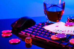 Game chips and cash on a dimly lit keyboard during an exciting gaming night at home photo