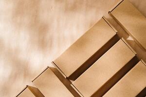 Brown cardboard boxes arranged on a neutral background in a warehouse setting during daylight hours photo