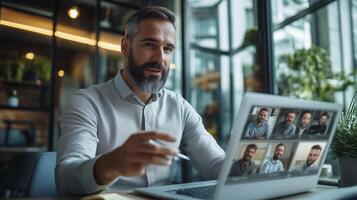 Man engaging in a virtual meeting on a laptop in a modern office space during daylight hours photo