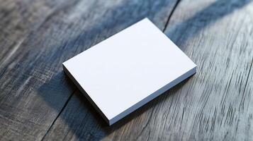 A blank notepad placed on a wooden surface, illuminated by natural light during the daytime, ready for jotting down ideas or notes photo