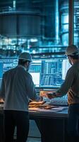 Engineers analyze data on large screens in a modern control room during evening shift at a high-tech facility photo