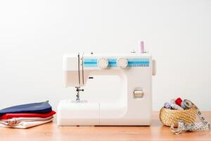 A sewing machine with colorful threads and fabric in a bright crafting space for creative projects photo