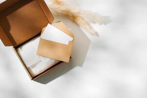 Delivery package with a blank envelope and decorative elements on a light background photo