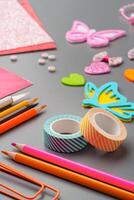 Crafting materials and tools arranged on a gray surface during a creative project photo