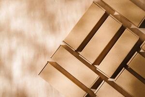 Brown cardboard boxes arranged on a neutral background in a warehouse setting during daylight hours photo