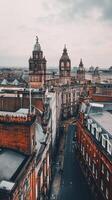 Aerial view of historic buildings with clock towers in a bustling urban landscape under a cloudy sky photo