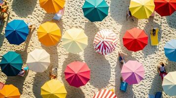 Colorful beach umbrellas provide shade for sunbathers enjoying a sunny day at the seaside during summer, creating a vibrant atmosphere photo