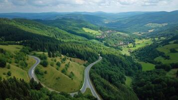 Scenic view of winding road through lush green hills in a mountainous area on a sunny day photo