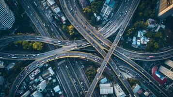 Aerial view of a busy urban interchange with flowing traffic and surrounding cityscape during daylight photo