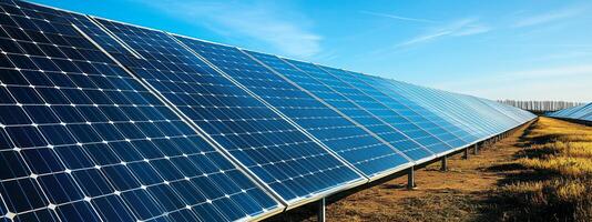 A vast array of solar panels harnessing renewable energy under a clear blue sky at a solar farm during daylight hours photo