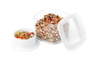 Nutritious seed mix served in a bowl with additional snacks for pet at home photo