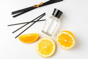 Aromatic display of essential oils with citrus fruit and chopsticks on a minimalist background photo