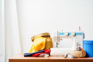 A sewing machine with colorful threads and fabric in a bright crafting space for creative projects photo