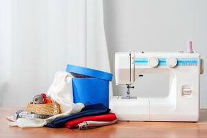 A sewing machine with colorful threads and fabric in a bright crafting space for creative projects photo